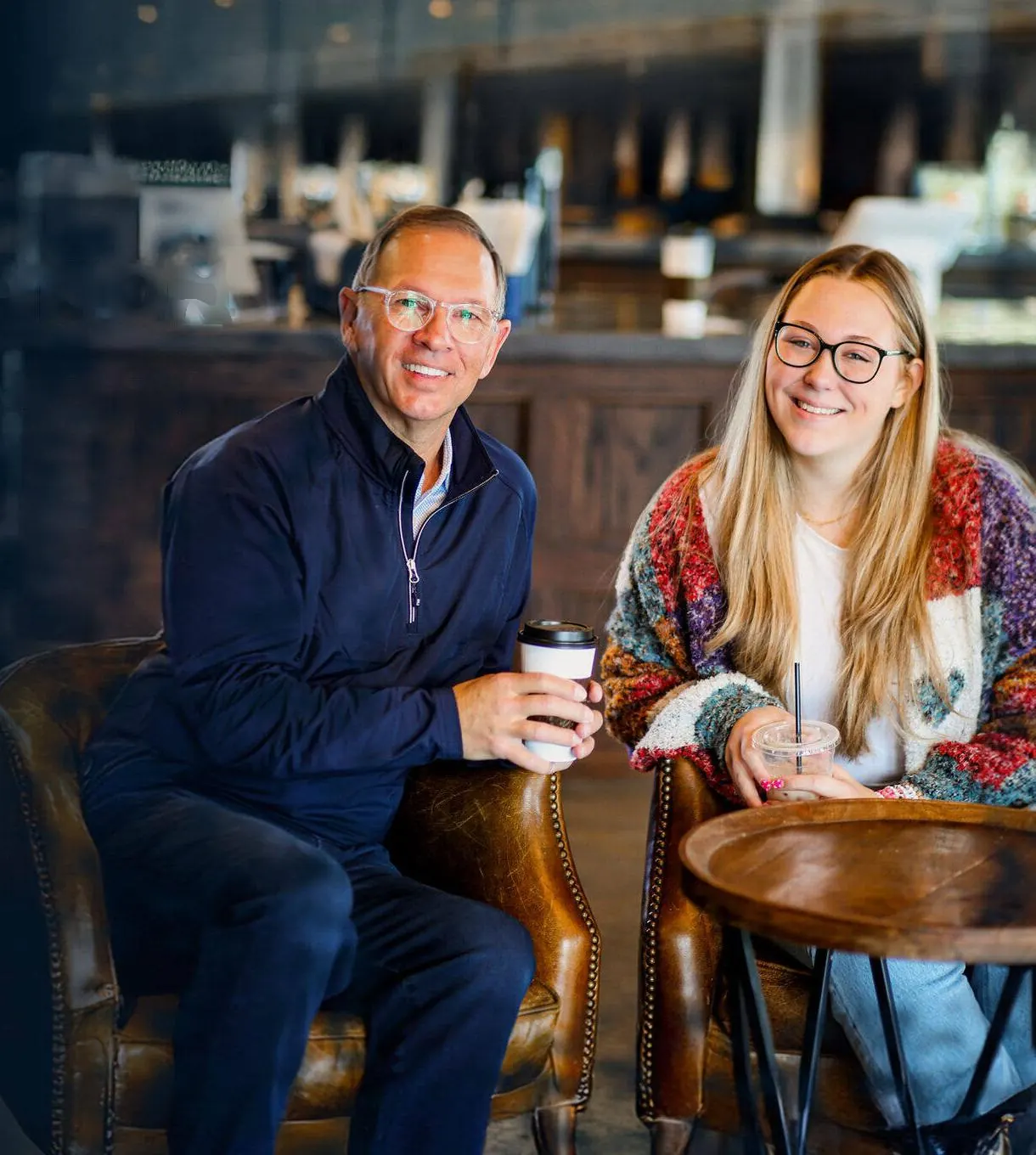 Rex and Eva Davis smiling over coffee at a café table